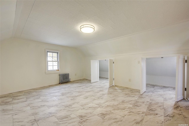 additional living space with radiator and vaulted ceiling