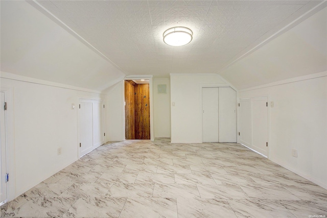 bonus room featuring a textured ceiling and vaulted ceiling