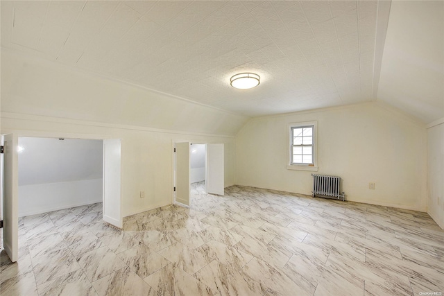 bonus room featuring radiator heating unit and lofted ceiling