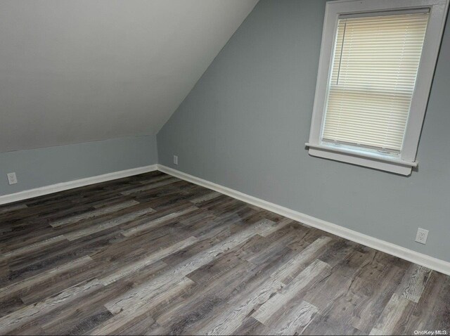 bonus room featuring dark hardwood / wood-style floors and lofted ceiling