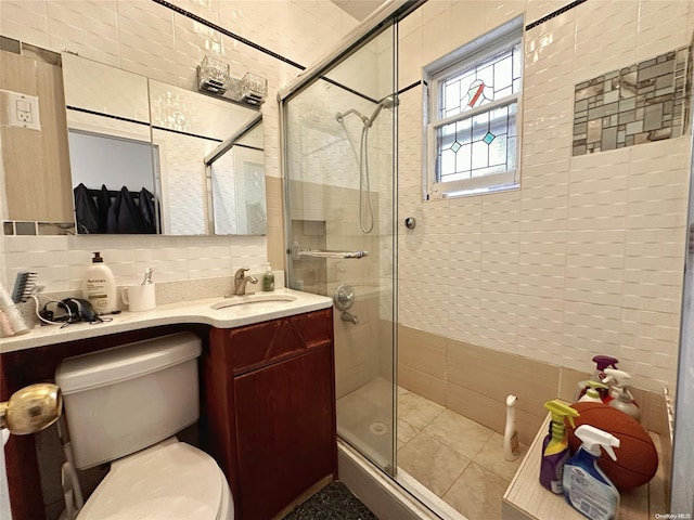 bathroom featuring vanity, toilet, tile walls, tasteful backsplash, and an enclosed shower