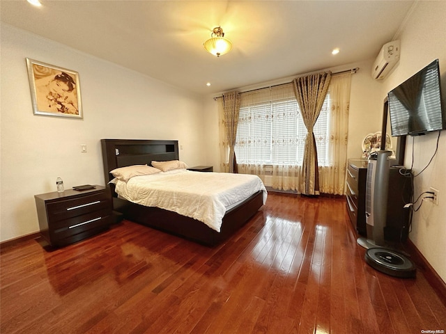 bedroom featuring dark wood-type flooring and a wall unit AC