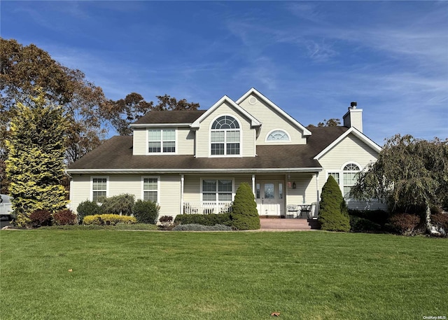11 Sherri Ct, Speonk, NY 11972 - view of front of home featuring a front yard, a chimney, covered porch, and roof with shingles