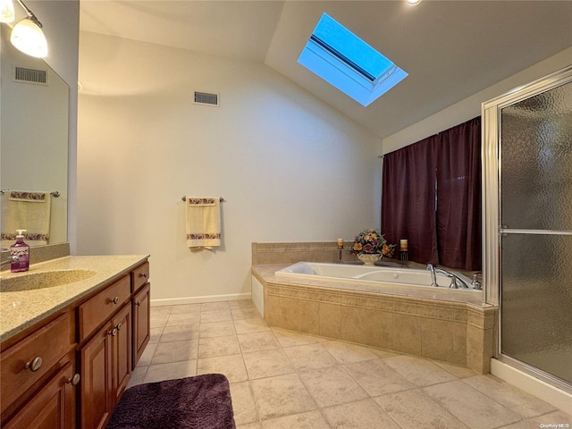 bathroom with tile patterned floors, lofted ceiling with skylight, vanity, and shower with separate bathtub