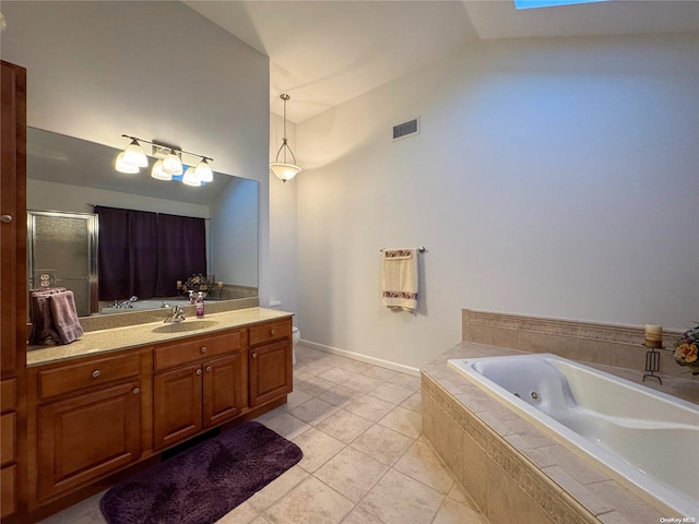 bathroom featuring tile patterned flooring, vanity, lofted ceiling with skylight, and plus walk in shower