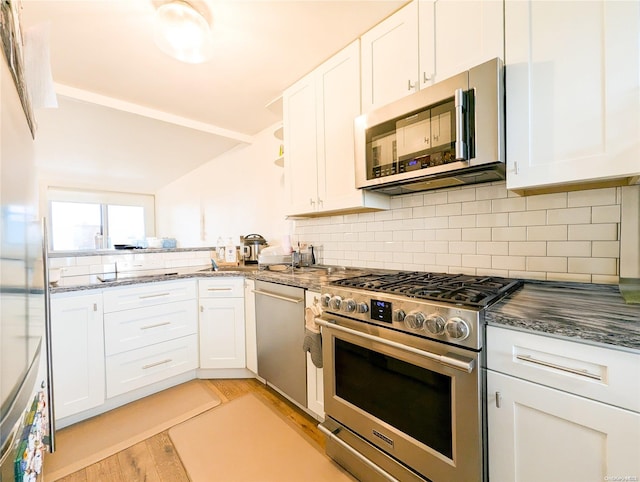 kitchen featuring white cabinets, light hardwood / wood-style floors, and stainless steel appliances