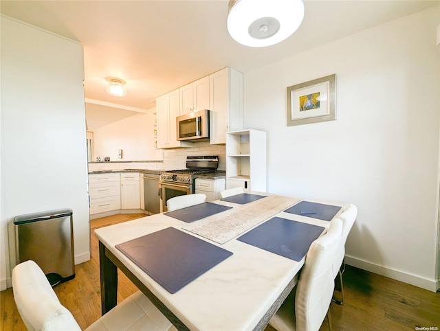 dining space with dark hardwood / wood-style floors