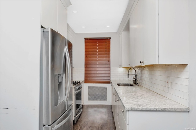 kitchen featuring stainless steel appliances, white cabinetry, dark hardwood / wood-style floors, and sink