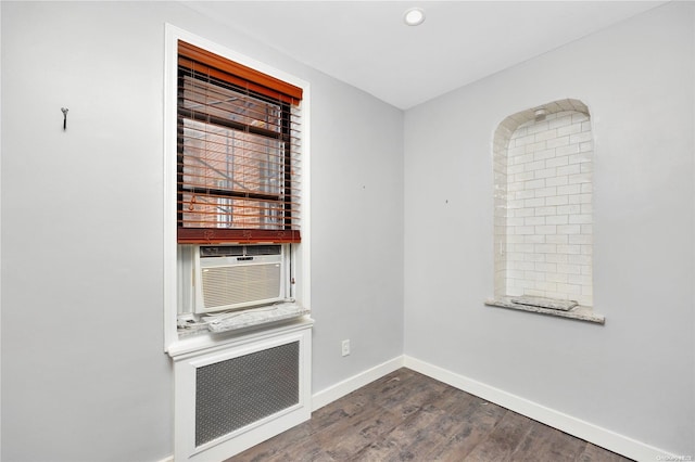 empty room featuring dark hardwood / wood-style floors and cooling unit