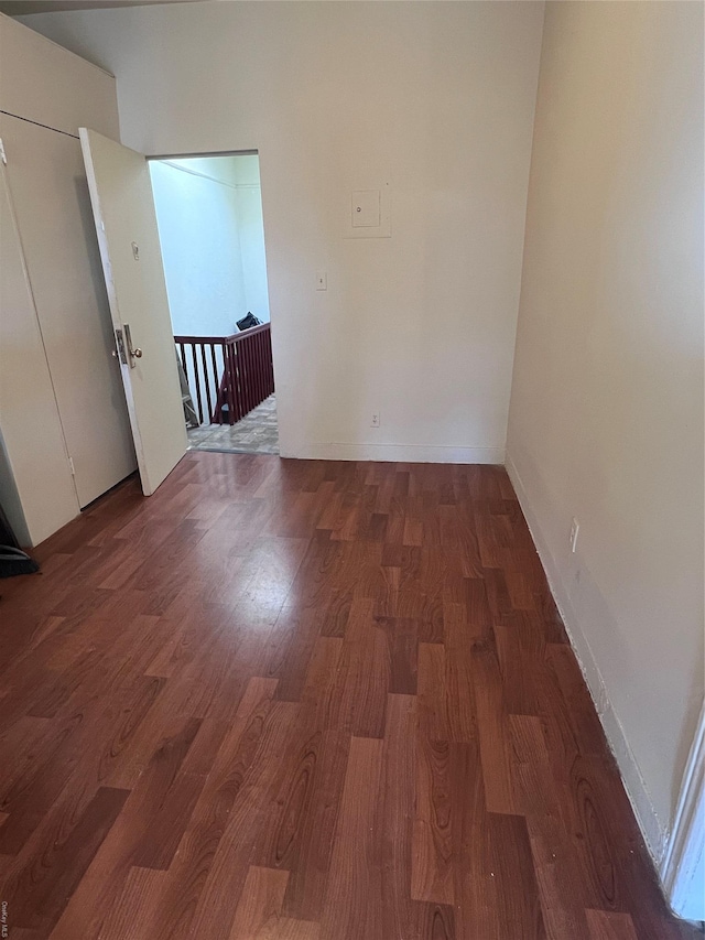 spare room with dark wood-type flooring