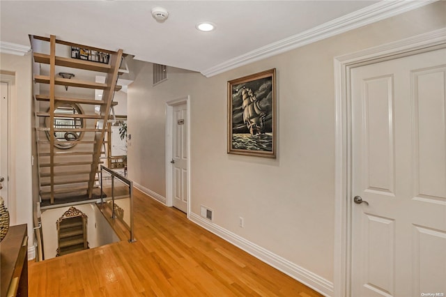 corridor featuring hardwood / wood-style floors and crown molding