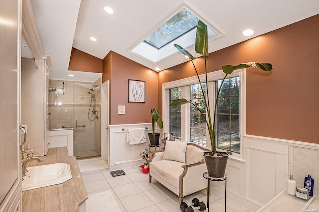 bathroom featuring tile patterned floors, vanity, an enclosed shower, and lofted ceiling with skylight