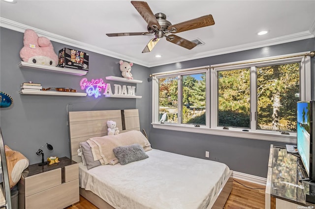 bedroom with wood-type flooring, ceiling fan, and ornamental molding