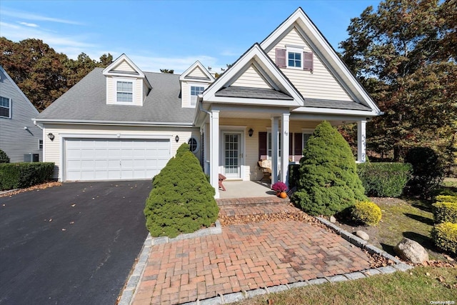 view of front of house featuring a porch and a garage