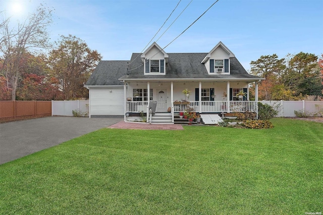 new england style home featuring covered porch and a front lawn