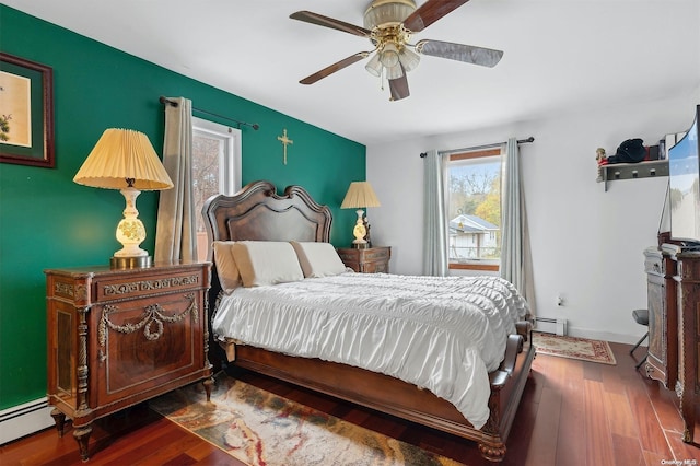 bedroom featuring ceiling fan, dark wood-type flooring, and a baseboard heating unit