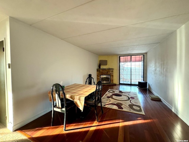 dining room featuring a fireplace and hardwood / wood-style floors