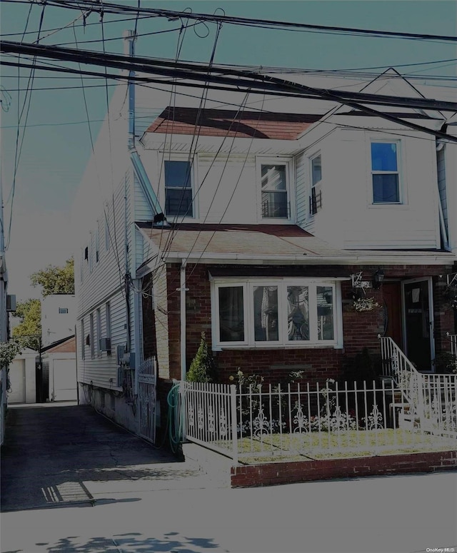 view of front of house with a garage and an outdoor structure