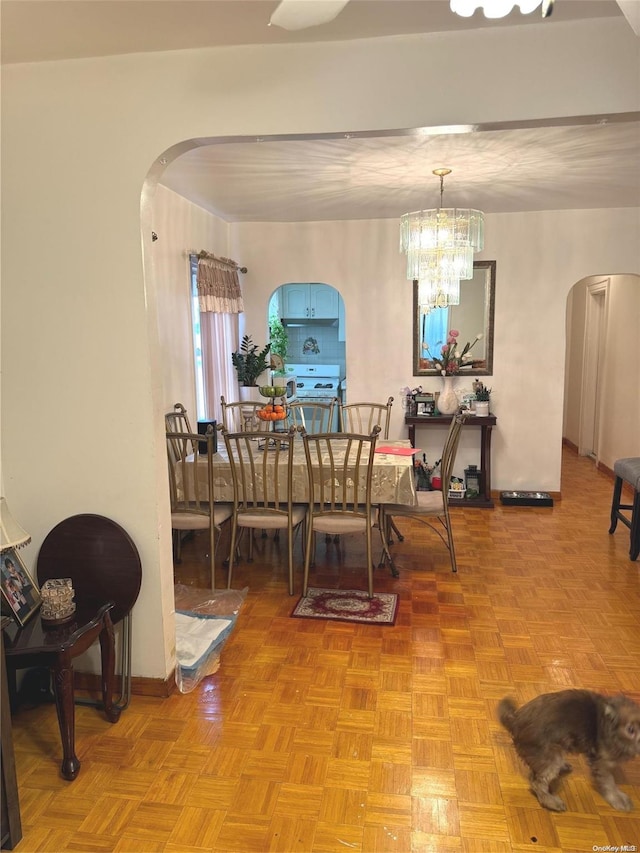 dining room featuring light parquet floors and a chandelier