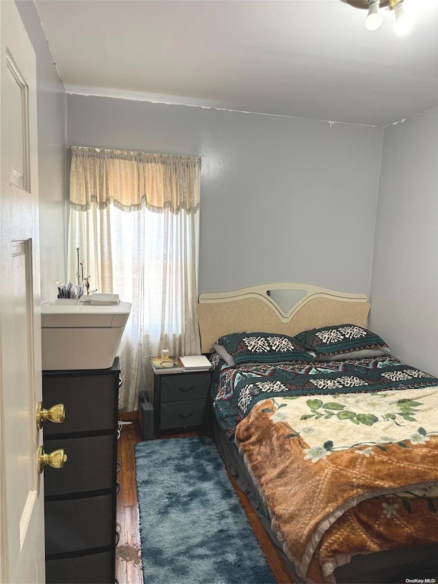 bedroom featuring dark hardwood / wood-style flooring