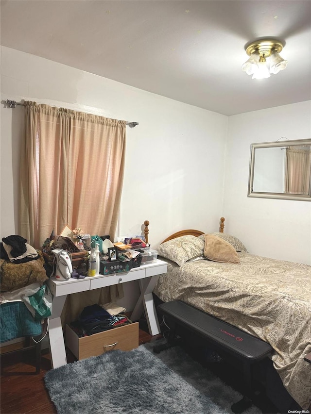 bedroom with dark hardwood / wood-style flooring