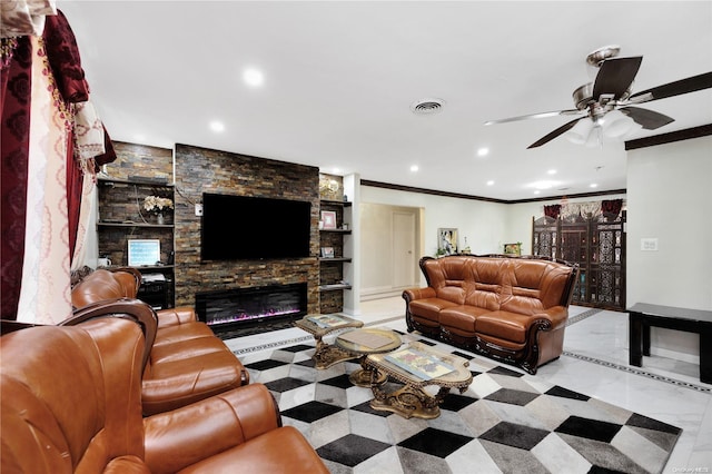 living room with built in shelves, a stone fireplace, ceiling fan, and crown molding