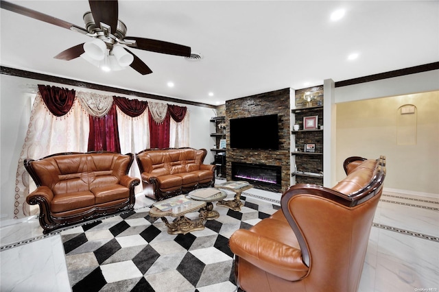 living room with a stone fireplace, ceiling fan, and ornamental molding