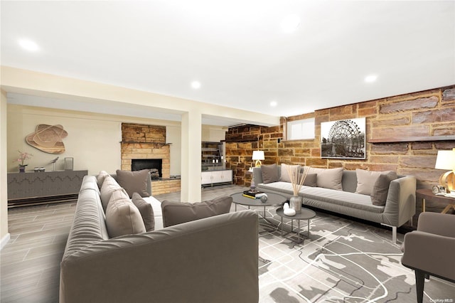 living room with wood-type flooring and a fireplace