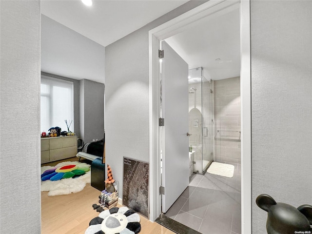 bathroom featuring walk in shower and hardwood / wood-style flooring