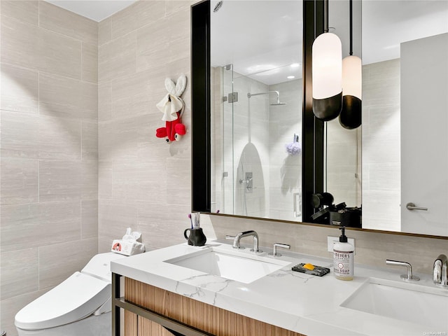 bathroom featuring walk in shower, vanity, toilet, and tile walls