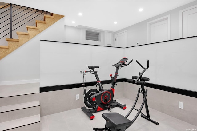 exercise room with light tile patterned floors