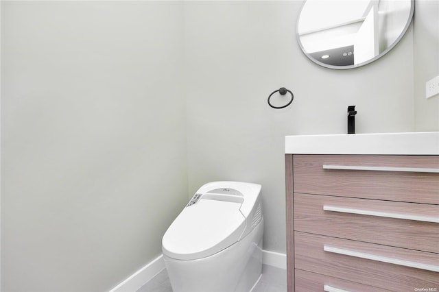 bathroom featuring tile patterned floors, vanity, and toilet