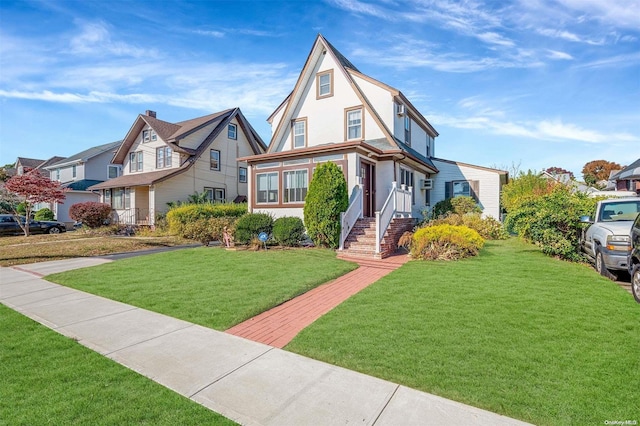 tudor home featuring a front lawn