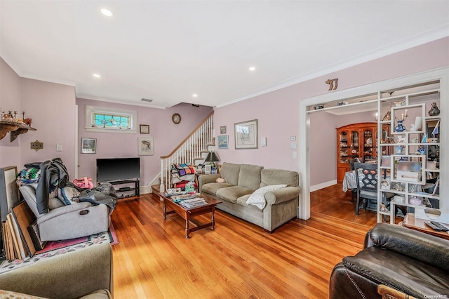 living room with hardwood / wood-style flooring and crown molding