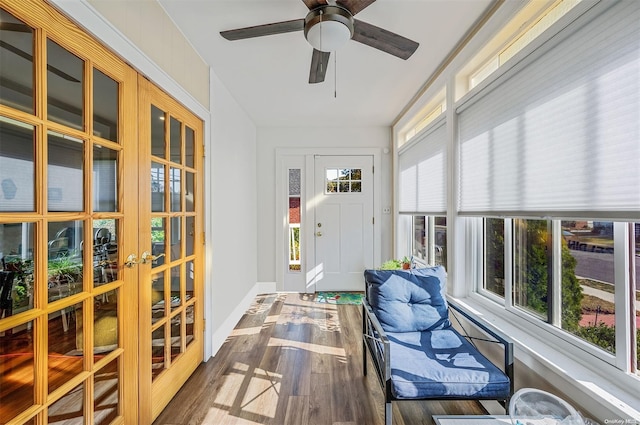 sunroom / solarium with plenty of natural light, ceiling fan, and french doors