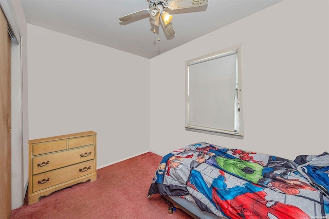 carpeted bedroom featuring a closet and ceiling fan