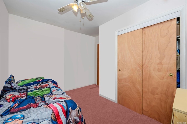 bedroom featuring ceiling fan, a closet, and carpet