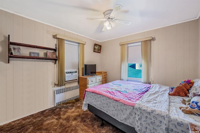 bedroom with radiator, dark colored carpet, cooling unit, crown molding, and ceiling fan