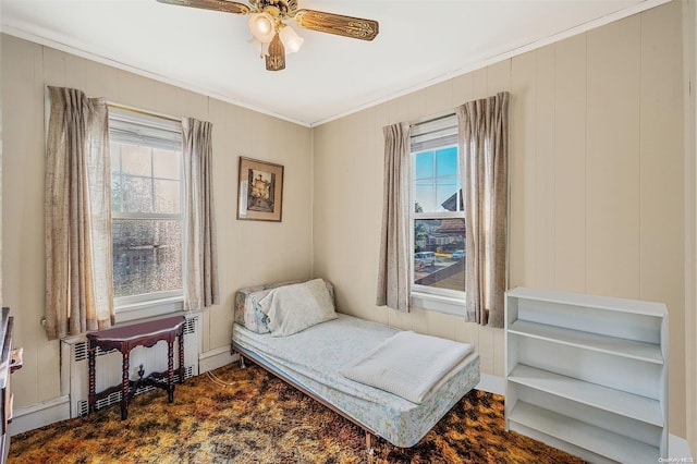 bedroom with ceiling fan, ornamental molding, and radiator