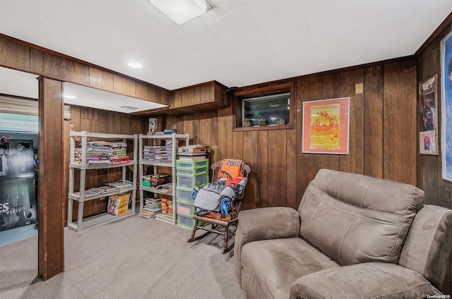 sitting room with light carpet and wooden walls