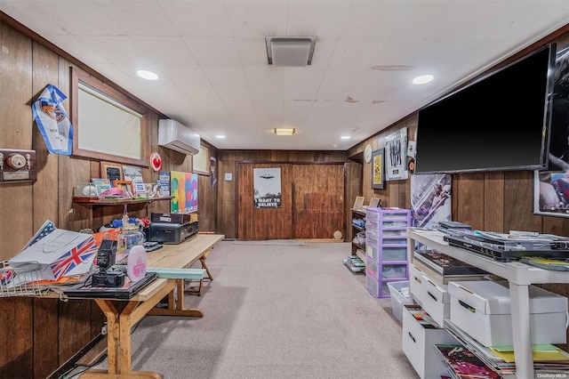 office featuring a wall mounted AC, wooden walls, and light carpet