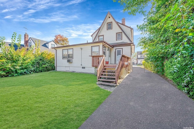 view of front of house with cooling unit and a front yard