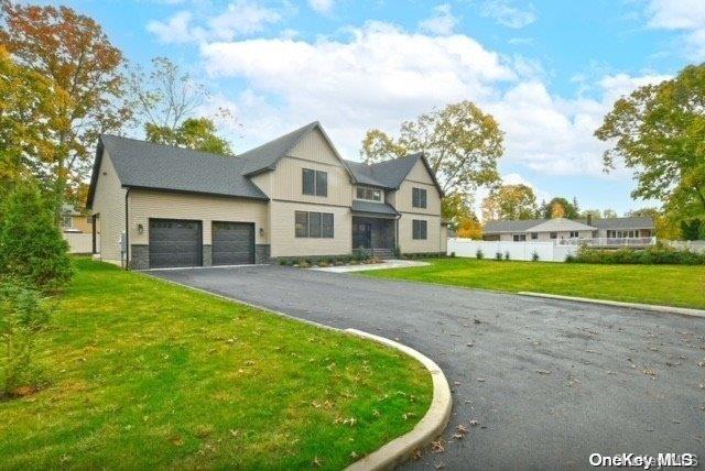 view of front of house with a garage and a front lawn