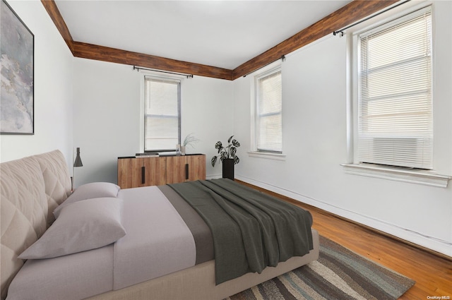37-21 80th St Unit 3M, Jackson Heights, NY 11372 - bedroom featuring wood finished floors, beam ceiling, and baseboards