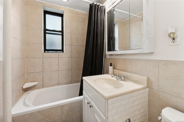 full bathroom with vanity, toilet, shower / bathtub combination with curtain, and tile walls