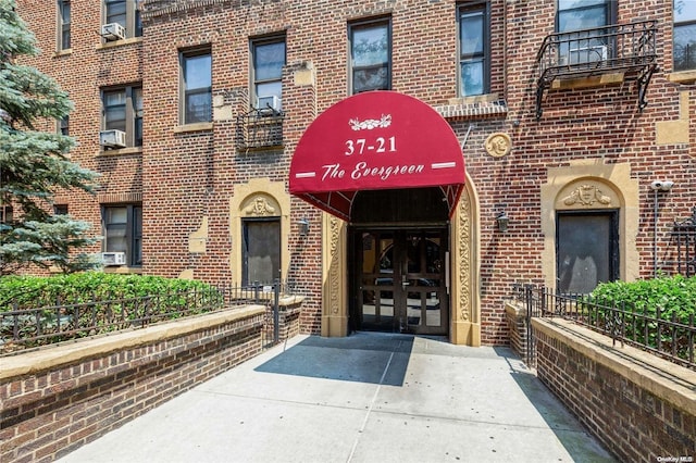 37-21 80th St Unit 3M, Jackson Heights, NY 11372 - view of exterior entry featuring french doors and brick siding