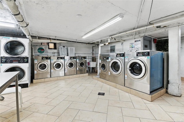 laundry room with stacked washer / drying machine and washing machine and clothes dryer