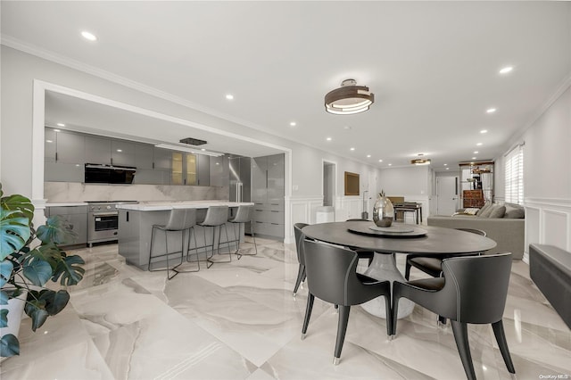 dining space featuring crown molding