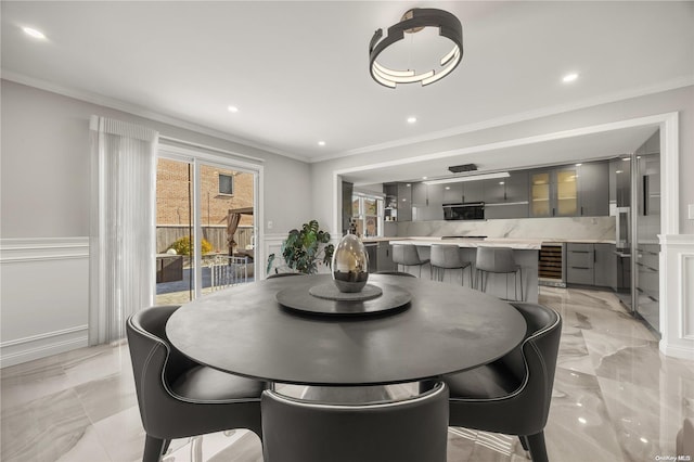 dining room with wine cooler and ornamental molding