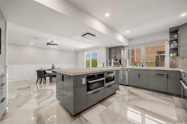 kitchen featuring appliances with stainless steel finishes, gray cabinets, and sink